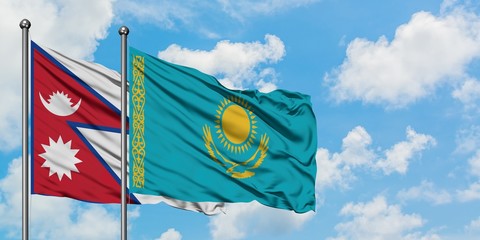 Nepal and Kazakhstan flag waving in the wind against white cloudy blue sky together. Diplomacy concept, international relations.