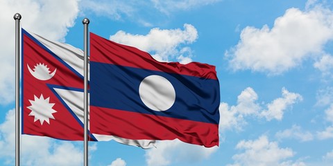 Nepal and Laos flag waving in the wind against white cloudy blue sky together. Diplomacy concept, international relations.