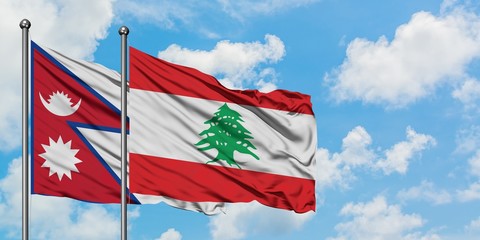 Nepal and Lebanon flag waving in the wind against white cloudy blue sky together. Diplomacy concept, international relations.