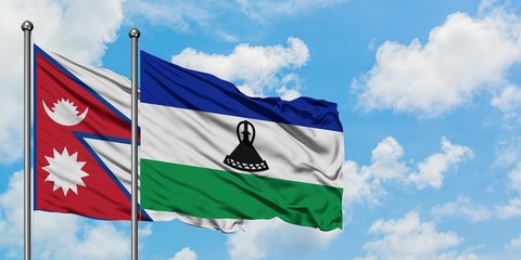 Nepal and Lesotho flag waving in the wind against white cloudy blue sky together. Diplomacy concept, international relations.