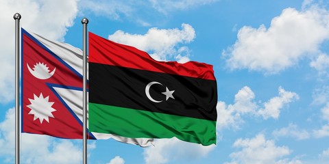 Nepal and Libya flag waving in the wind against white cloudy blue sky together. Diplomacy concept, international relations.