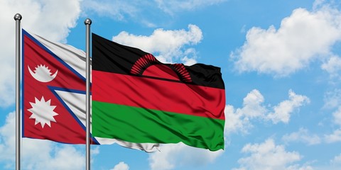 Nepal and Malawi flag waving in the wind against white cloudy blue sky together. Diplomacy concept, international relations.