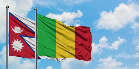 Nepal and Mali flag waving in the wind against white cloudy blue sky together. Diplomacy concept, international relations.