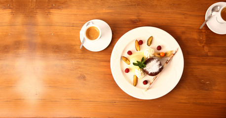 dessert plate with coffee on wooden table