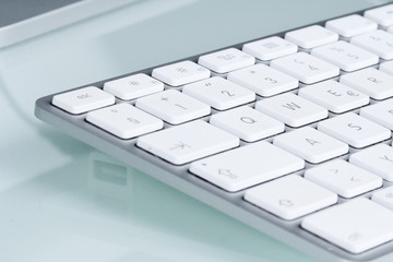 computer keyboard on glass table top