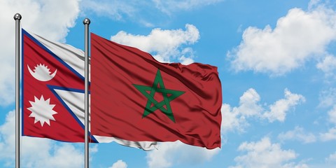 Nepal and Morocco flag waving in the wind against white cloudy blue sky together. Diplomacy concept, international relations.