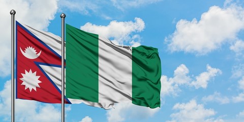 Nepal and Nigeria flag waving in the wind against white cloudy blue sky together. Diplomacy concept, international relations.