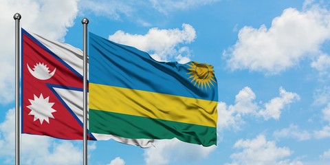 Nepal and Rwanda flag waving in the wind against white cloudy blue sky together. Diplomacy concept, international relations.