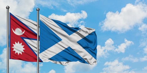Nepal and Scotland flag waving in the wind against white cloudy blue sky together. Diplomacy concept, international relations.
