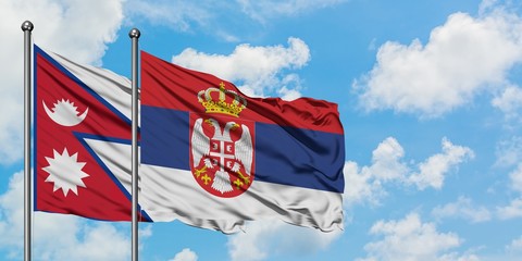 Nepal and Serbia flag waving in the wind against white cloudy blue sky together. Diplomacy concept,...