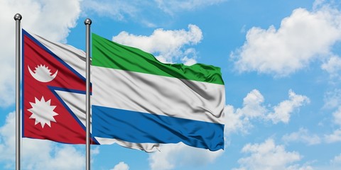 Nepal and Sierra Leone flag waving in the wind against white cloudy blue sky together. Diplomacy concept, international relations.