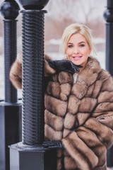 Vogue concept. Beautiful lady in holidays, modern woman wear fur coat look . Fashionable lady...