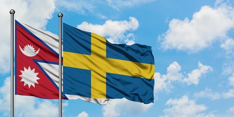 Nepal and Sweden flag waving in the wind against white cloudy blue sky together. Diplomacy concept, international relations.