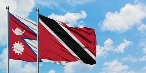 Nepal and Trinidad And Tobago flag waving in the wind against white cloudy blue sky together. Diplomacy concept, international relations.