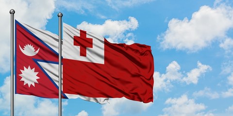 Nepal and Tonga flag waving in the wind against white cloudy blue sky together. Diplomacy concept, international relations.