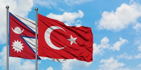 Nepal and Turkey flag waving in the wind against white cloudy blue sky together. Diplomacy concept, international relations.