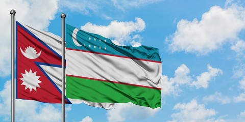 Nepal and Uzbekistan flag waving in the wind against white cloudy blue sky together. Diplomacy concept, international relations.