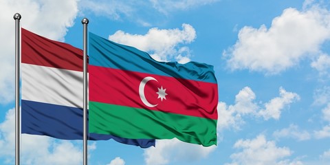 Netherlands and Azerbaijan flag waving in the wind against white cloudy blue sky together. Diplomacy concept, international relations.