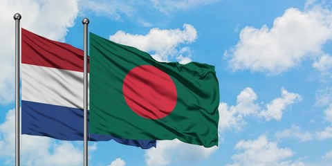 Netherlands and Bangladesh flag waving in the wind against white cloudy blue sky together. Diplomacy concept, international relations.