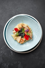 Seafood risotto on a dark background