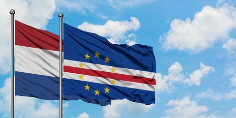 Netherlands and Cape Verde flag waving in the wind against white cloudy blue sky together. Diplomacy concept, international relations.