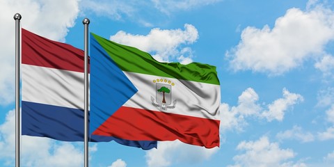 Netherlands and Equatorial Guinea flag waving in the wind against white cloudy blue sky together. Diplomacy concept, international relations.