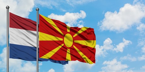 Netherlands and Macedonia flag waving in the wind against white cloudy blue sky together. Diplomacy concept, international relations.