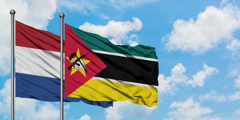 Netherlands and Mozambique flag waving in the wind against white cloudy blue sky together. Diplomacy concept, international relations.