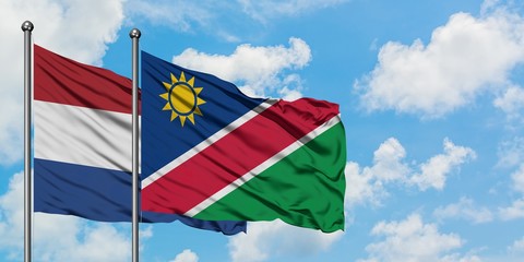 Netherlands and Namibia flag waving in the wind against white cloudy blue sky together. Diplomacy concept, international relations.