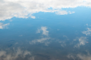 Naklejka na ściany i meble white clouds with reflection in the water