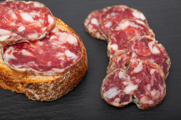 pork dry sausage on a slate plate