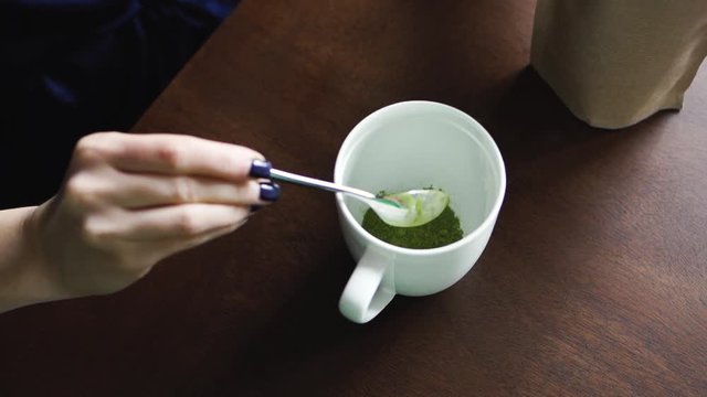 Woman making matcha green tea to breakfast