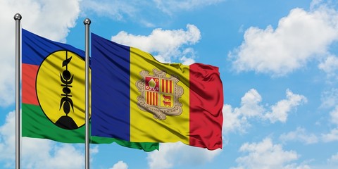 New Caledonia and Andorra flag waving in the wind against white cloudy blue sky together. Diplomacy concept, international relations.
