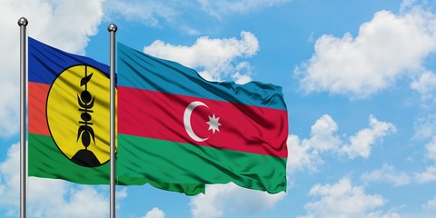 New Caledonia and Azerbaijan flag waving in the wind against white cloudy blue sky together. Diplomacy concept, international relations.