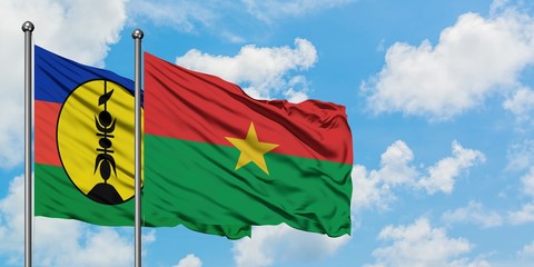 New Caledonia and Burkina Faso flag waving in the wind against white cloudy blue sky together. Diplomacy concept, international relations.