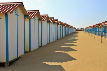 Closed beach huts on the famous Lido beach in Venice, in the low season in October. Lido di Venezia, Italy, Europe.