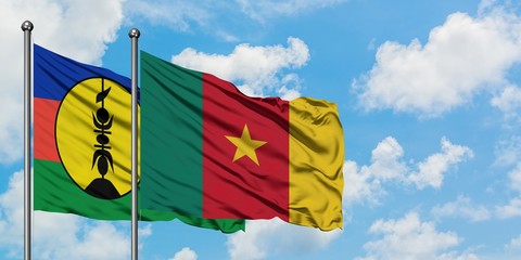 New Caledonia and Cameroon flag waving in the wind against white cloudy blue sky together. Diplomacy concept, international relations.