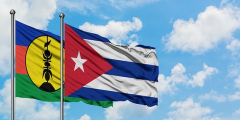 New Caledonia and Cuba flag waving in the wind against white cloudy blue sky together. Diplomacy concept, international relations.