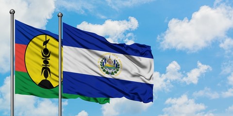 New Caledonia and El Salvador flag waving in the wind against white cloudy blue sky together. Diplomacy concept, international relations.