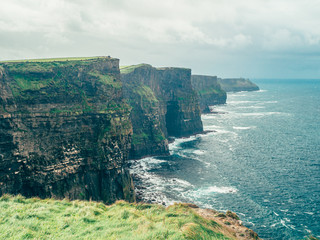 Dramatic scenery of the Cliffs of Moher in Moody weather in Ireland