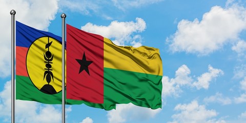 New Caledonia and Guinea Bissau flag waving in the wind against white cloudy blue sky together. Diplomacy concept, international relations.