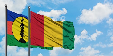 New Caledonia and Guinea flag waving in the wind against white cloudy blue sky together. Diplomacy concept, international relations.