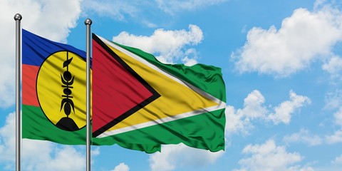 New Caledonia and Guyana flag waving in the wind against white cloudy blue sky together. Diplomacy concept, international relations.
