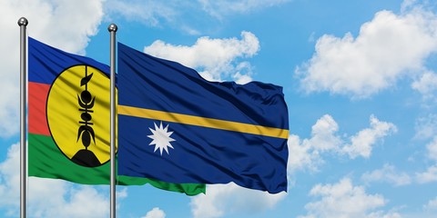 New Caledonia and Nauru flag waving in the wind against white cloudy blue sky together. Diplomacy concept, international relations.