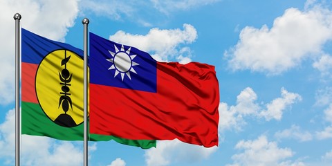 New Caledonia and Taiwan flag waving in the wind against white cloudy blue sky together. Diplomacy concept, international relations.