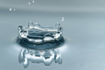 Beautiful splash of water drop on water surface, macro photo