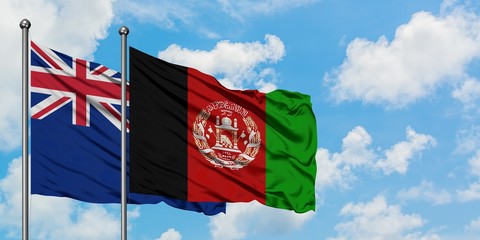 New Zealand and Afghanistan flag waving in the wind against white cloudy blue sky together. Diplomacy concept, international relations.