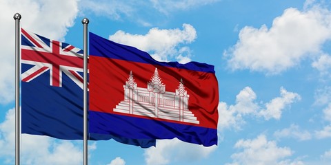 New Zealand and Cambodia flag waving in the wind against white cloudy blue sky together. Diplomacy concept, international relations.