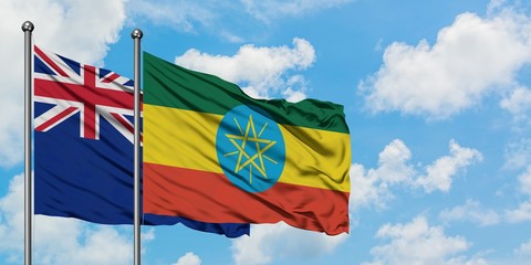 New Zealand and Ethiopia flag waving in the wind against white cloudy blue sky together. Diplomacy concept, international relations.