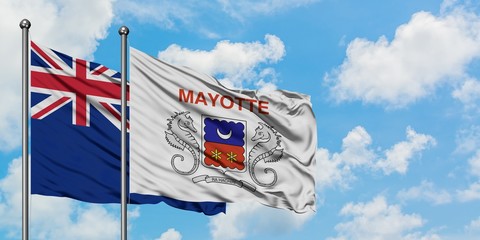 New Zealand and Mayotte flag waving in the wind against white cloudy blue sky together. Diplomacy concept, international relations.